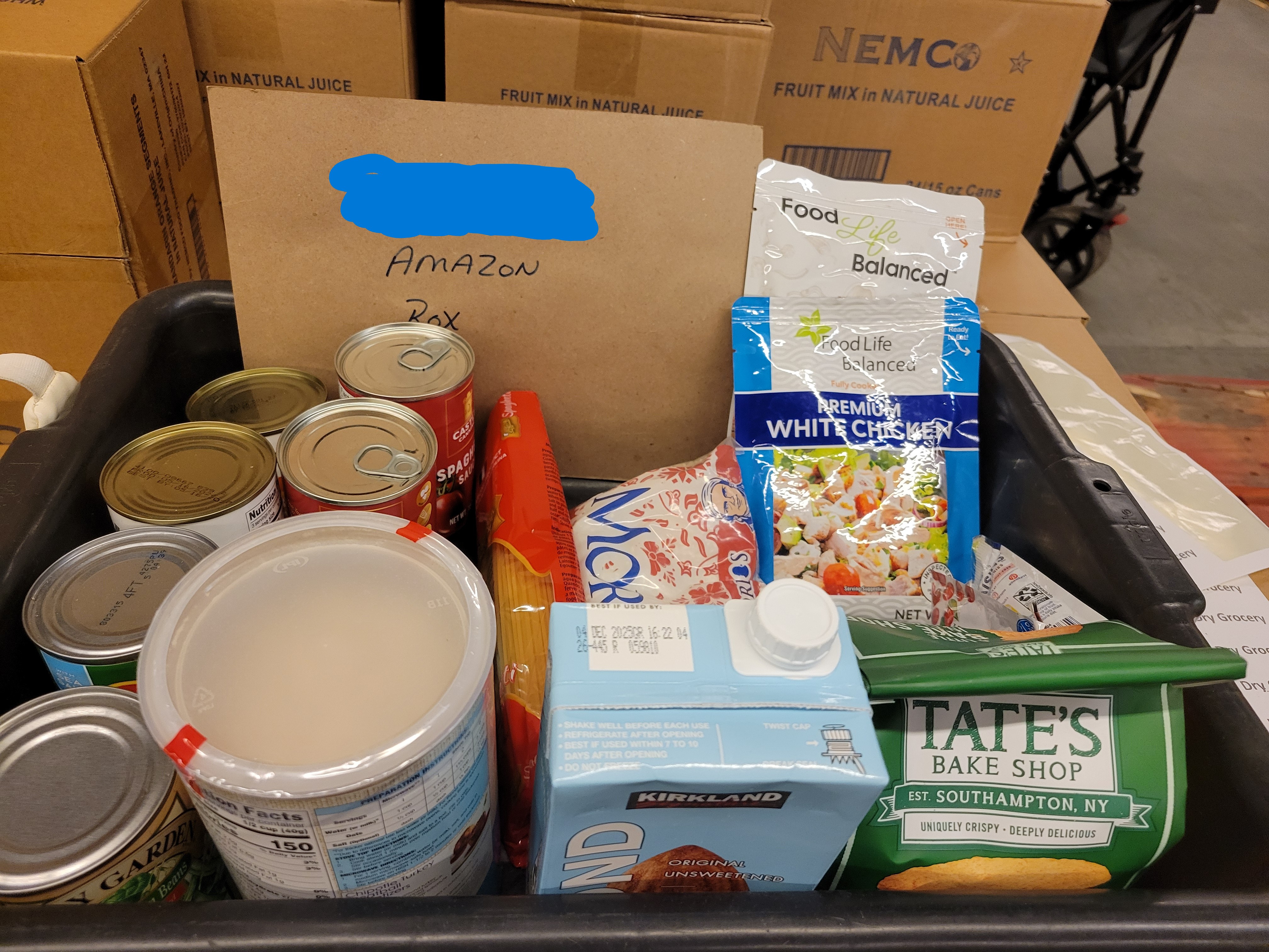 Dry goods and a amazon delivery box sample in a black tub.